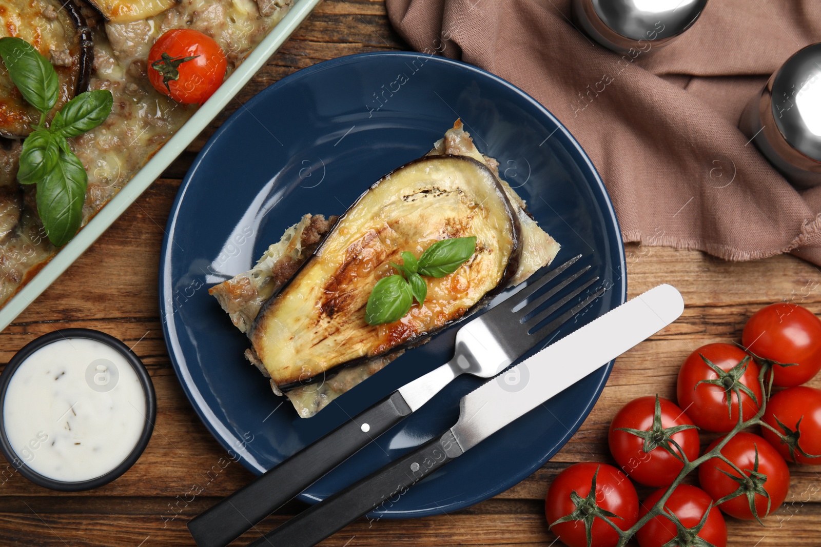 Photo of Delicious eggplant lasagna served on wooden table, flat lay