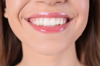Photo of Young woman with healthy teeth and beautiful smile, closeup