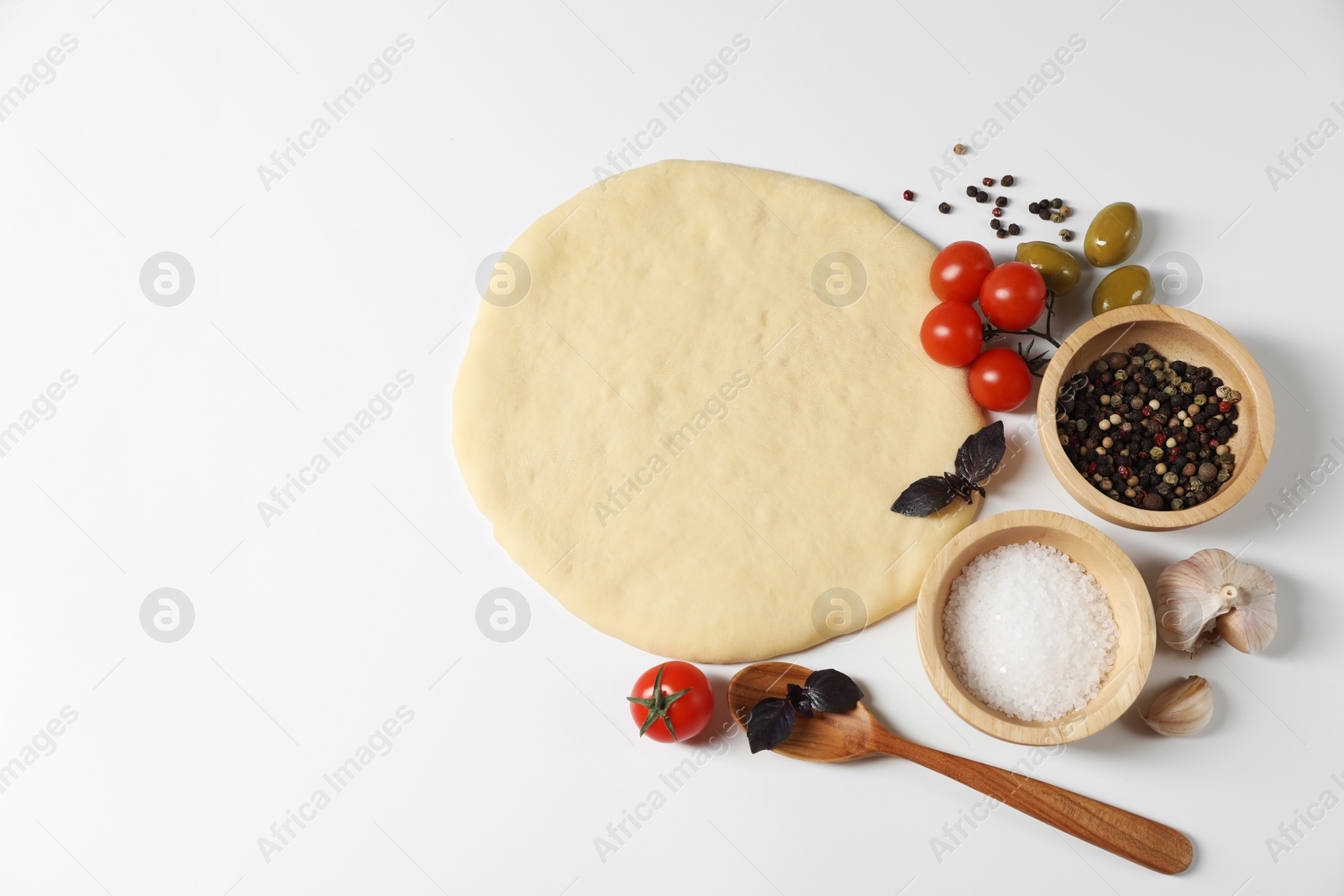 Photo of Fresh pizza dough and products on white background, flat lay. Space for text