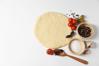 Fresh pizza dough and products on white background, flat lay. Space for text