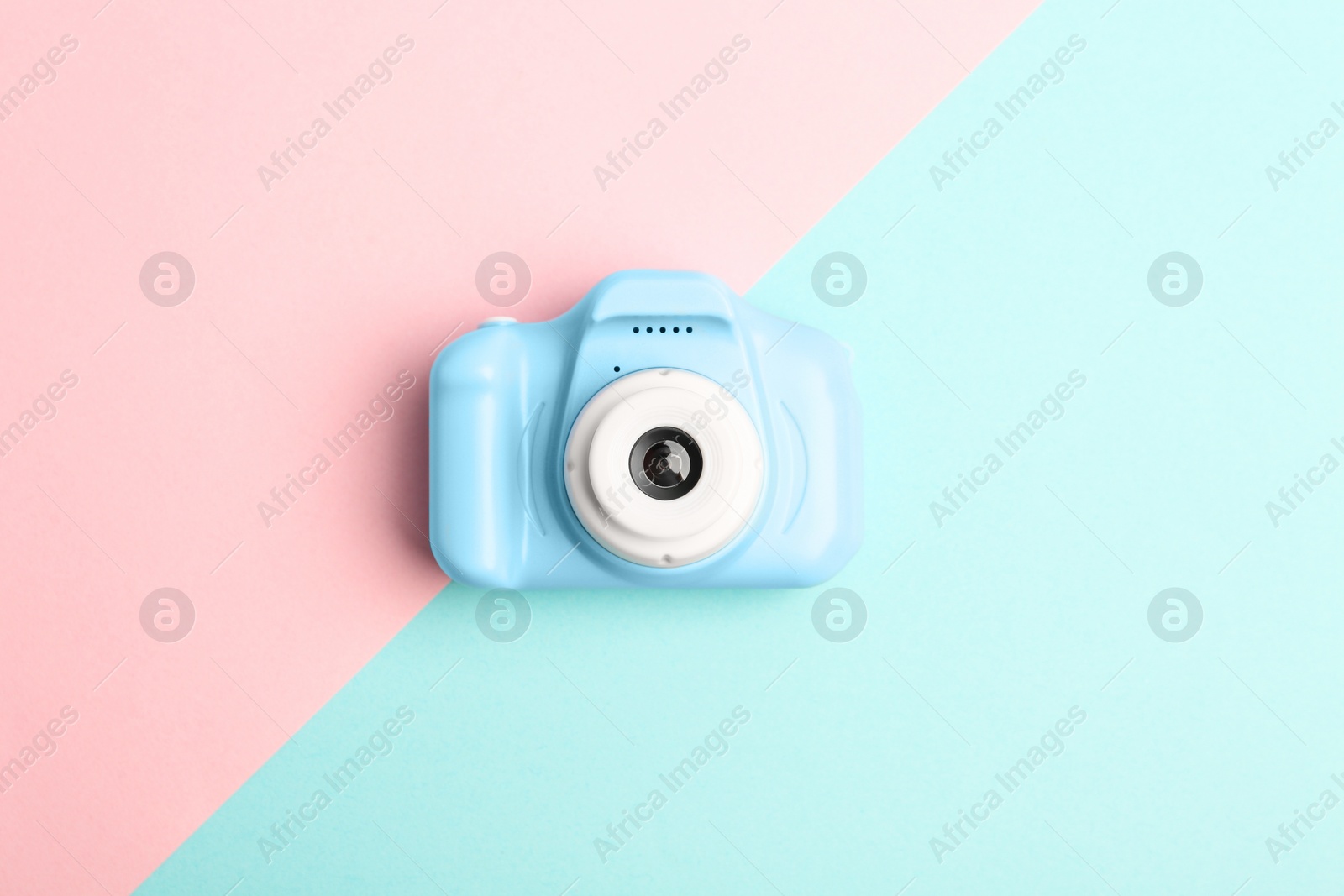 Photo of Light blue toy camera on color background, top view. Future photographer