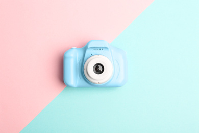 Photo of Light blue toy camera on color background, top view. Future photographer