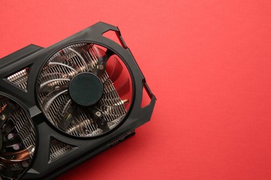 Photo of One graphics card on red background, top view. Space for text
