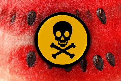 Image of Skull and crossbones sign on ripe watermelon, closeup. Be careful - toxic