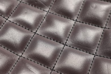 Photo of Brown natural leather with seams as background, closeup