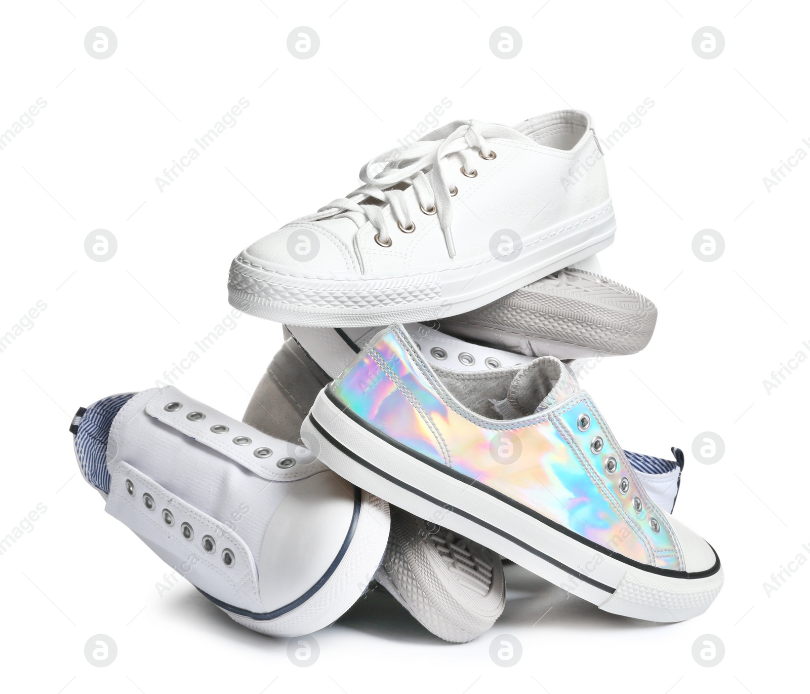 Photo of Heap of different sneakers on white background