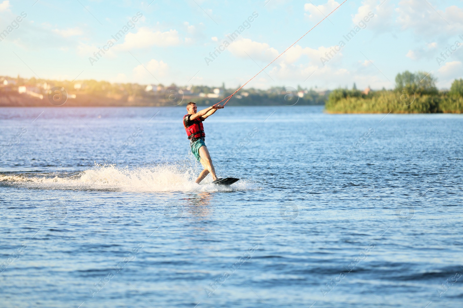 Photo of Man wakeboarding on river. Extreme water sport