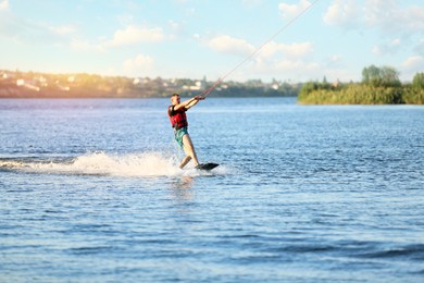 Man wakeboarding on river. Extreme water sport