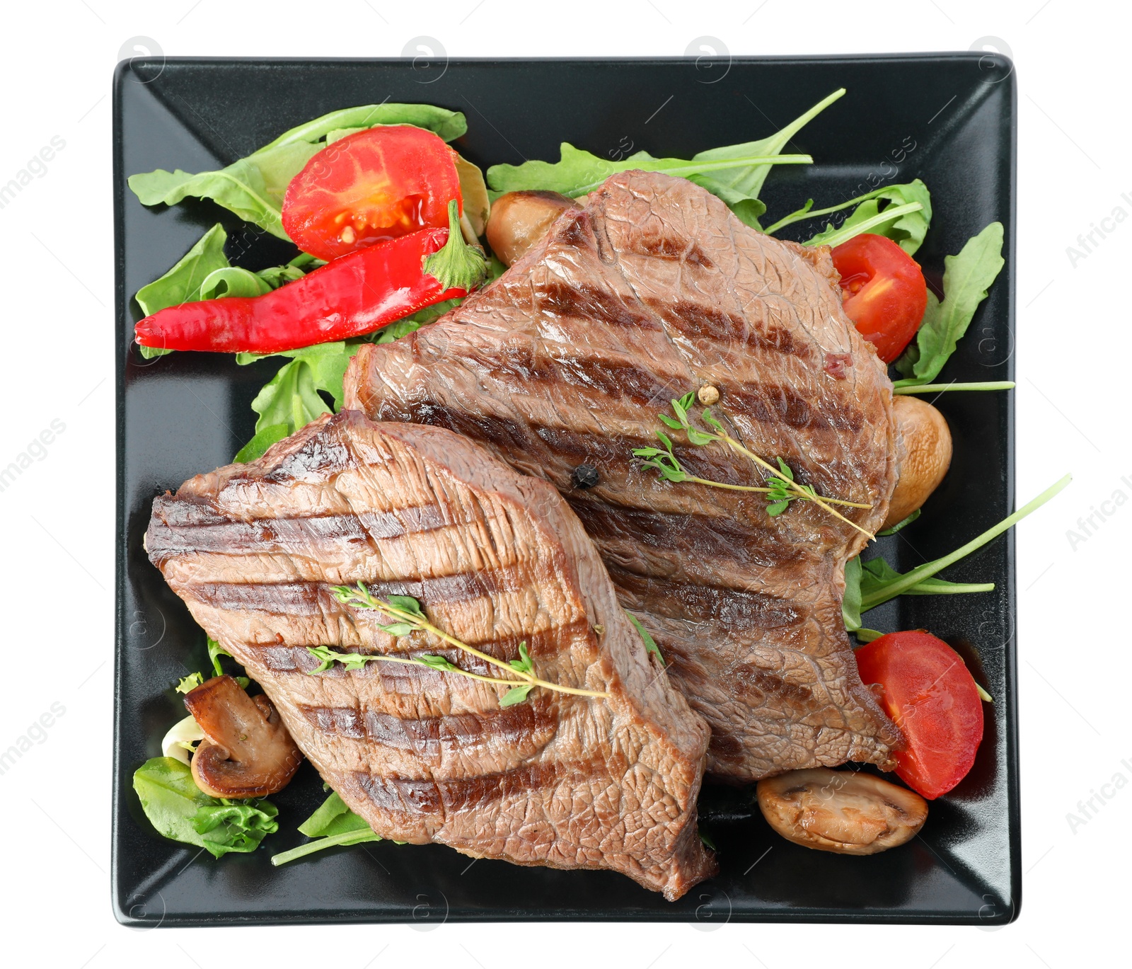 Photo of Plate with delicious beef steaks isolated on white, top view