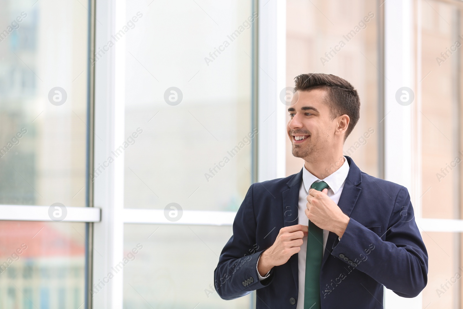 Photo of Young man in office wear on blurred background