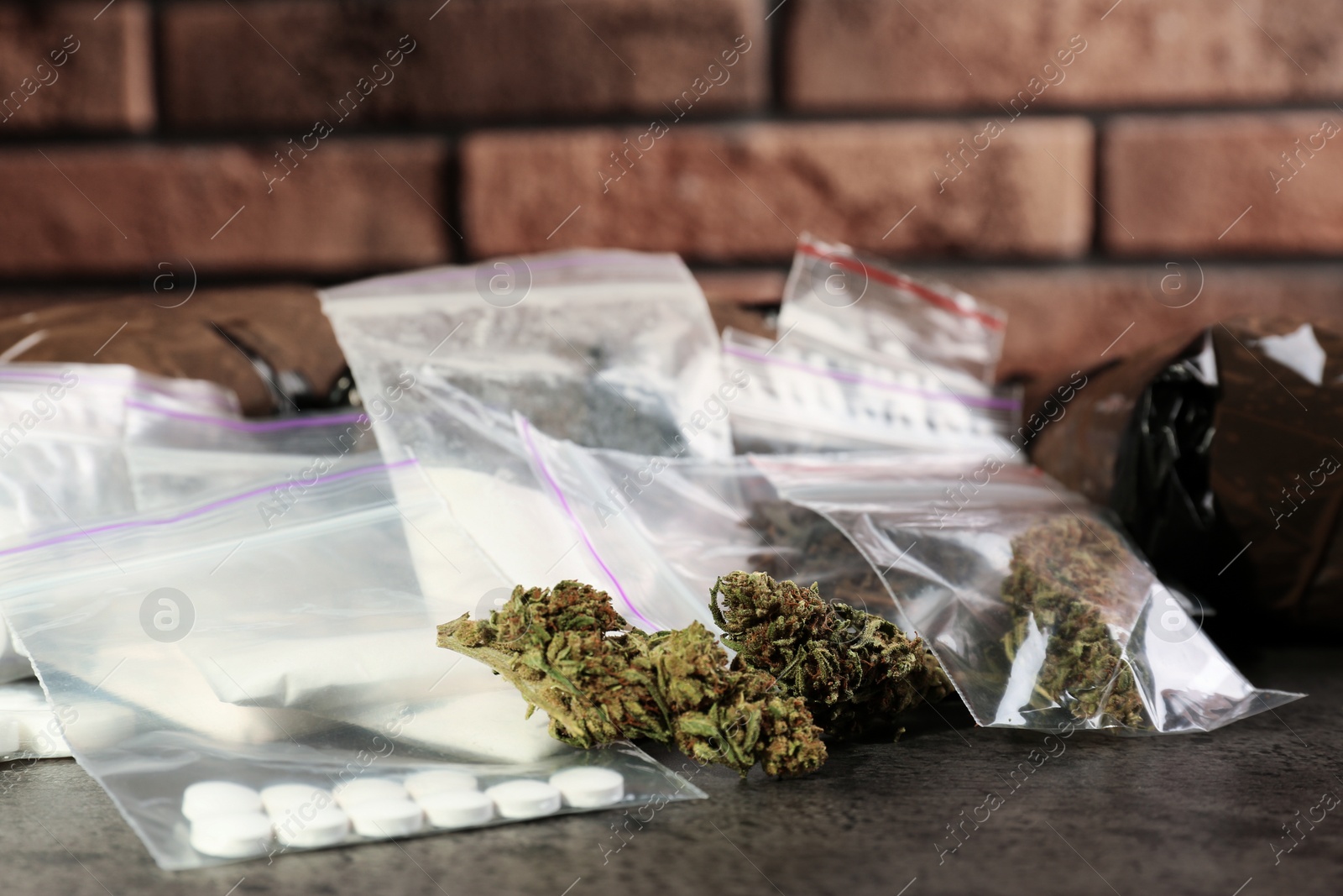 Photo of Hemp and other drugs in packages on grey  table