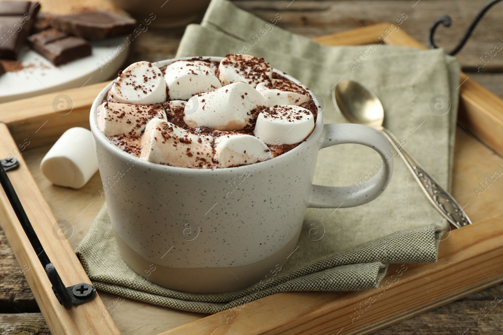 Photo of Delicious hot chocolate with marshmallows and cocoa powder on table, closeup