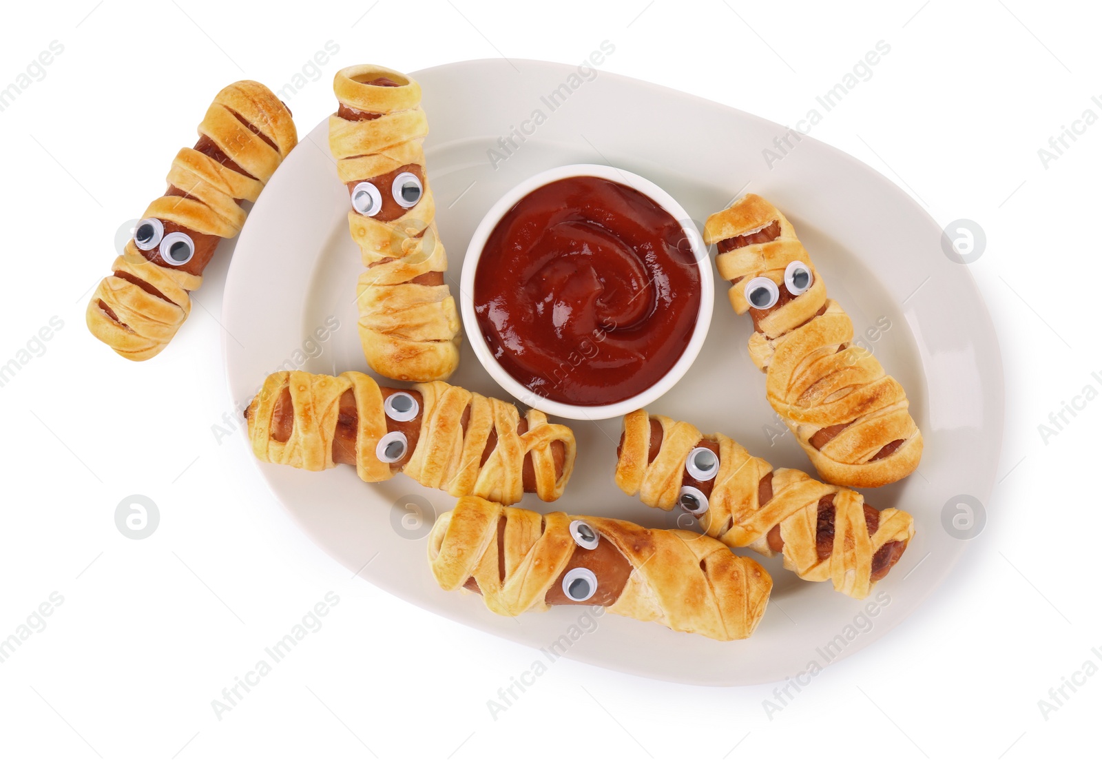 Photo of Plate with tasty sausage mummies for Halloween party and ketchup isolated on white, top view