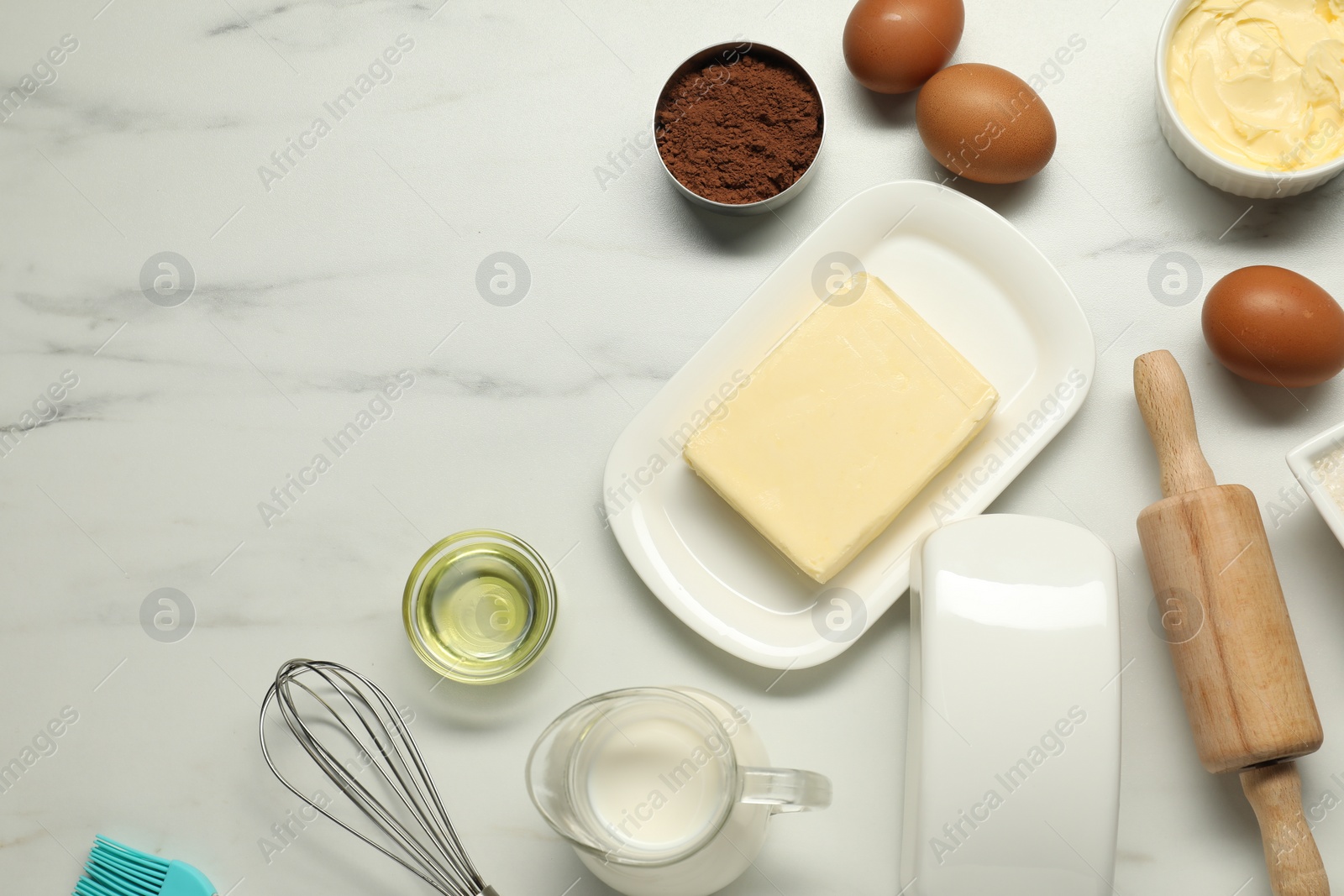 Photo of Flat lay composition with fresh butter among other products on white marble table. Space for text