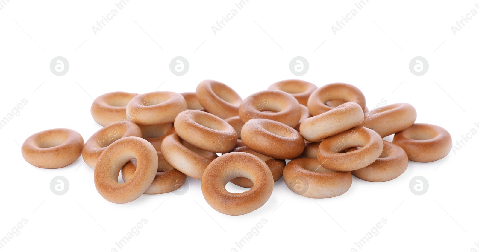 Photo of Pile of tasty dry bagels (sushki) on white background