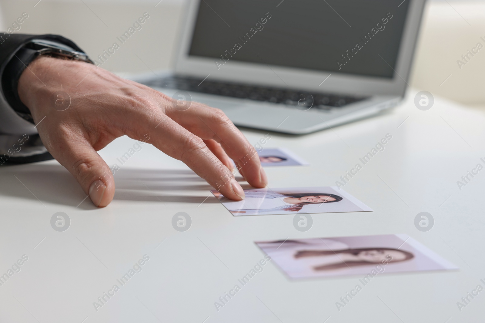 Photo of Human resources manager choosing employee among different applicants at table, closeup