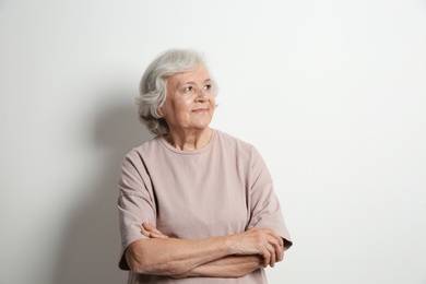 Photo of Portrait of elderly woman on light background