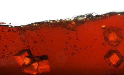 Closeup view of tasty refreshing cola with ice cubes on white background