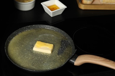 Photo of Melting butter in frying pan on cooktop