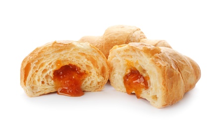 Tasty croissants with jam on white background