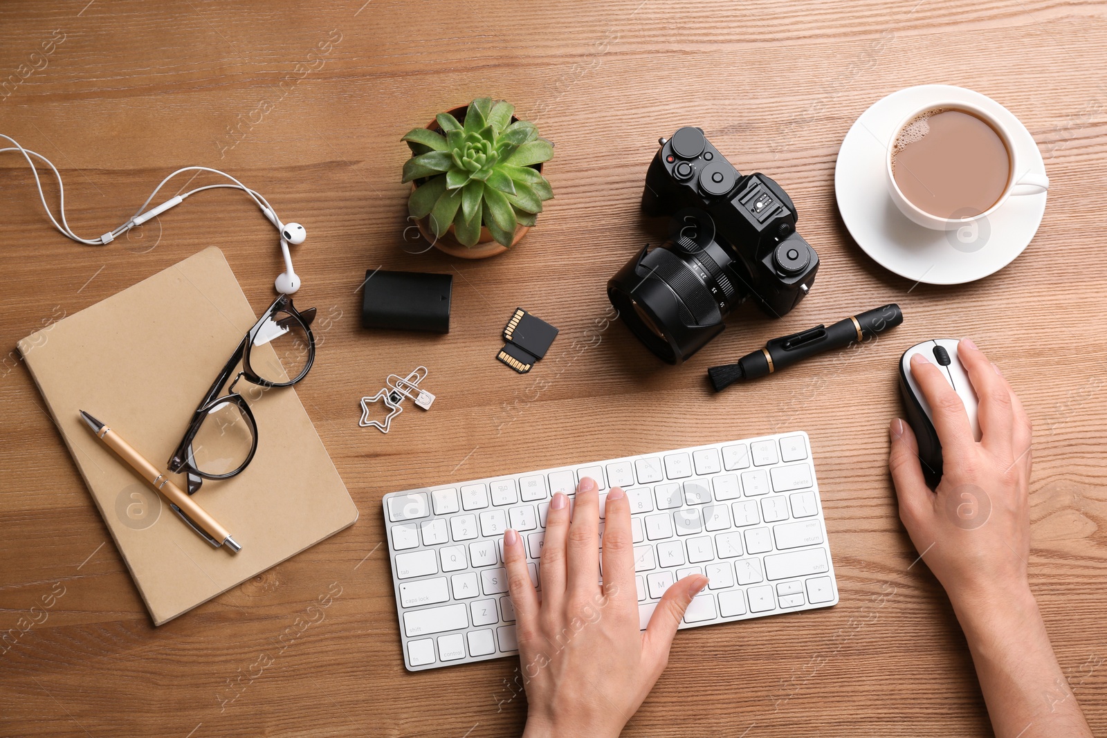 Photo of Woman using computer mouse and keyboard at office table, top view