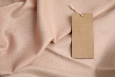 Warm beige cashmere garment with tag, closeup