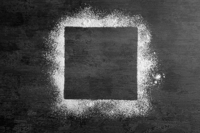 Square frame made of flour on gray background, top view. Space for text