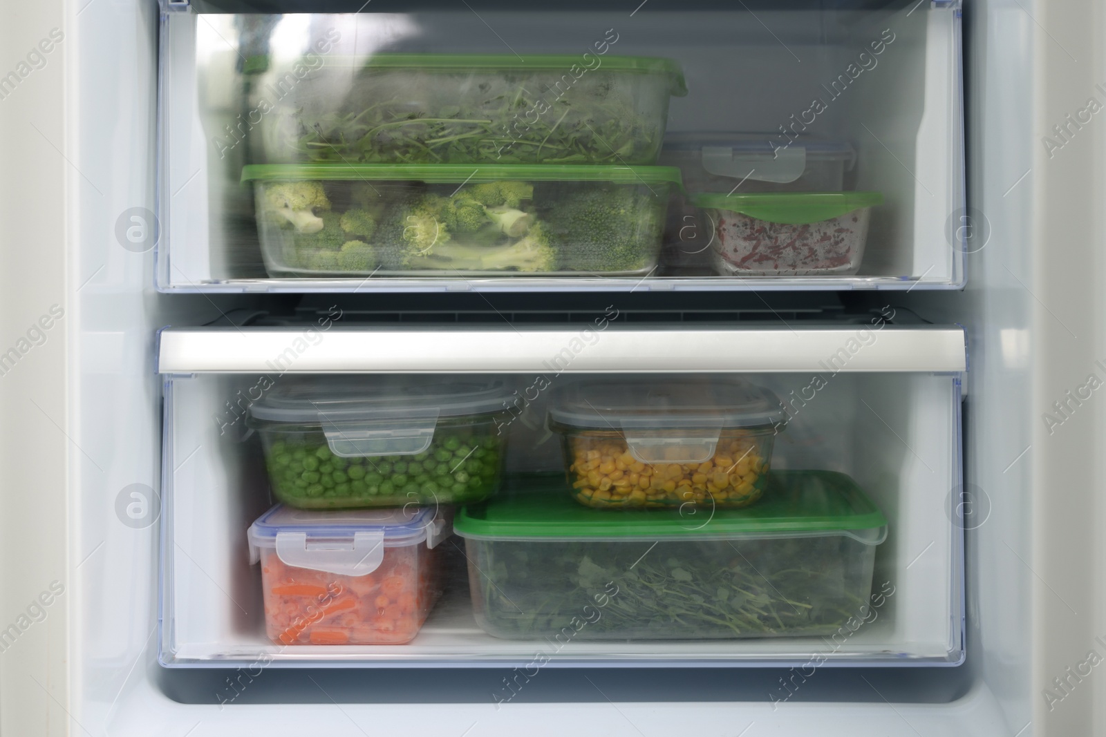 Photo of Plastic and glass containers with different fresh products in fridge. Food storage
