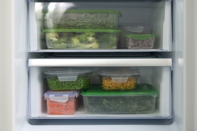 Photo of Plastic and glass containers with different fresh products in fridge. Food storage