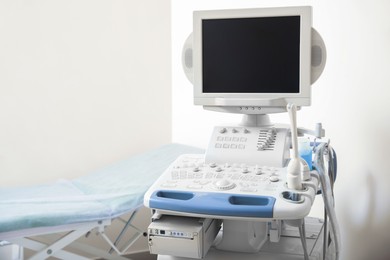 Photo of Ultrasound machine and examination table in hospital