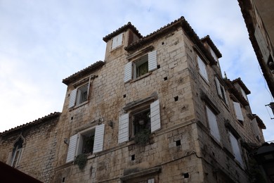 Photo of Beautiful old building against cloudy sky, low angle view