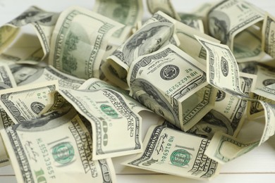 Photo of Money exchange. Dollar banknotes on white wooden background, closeup