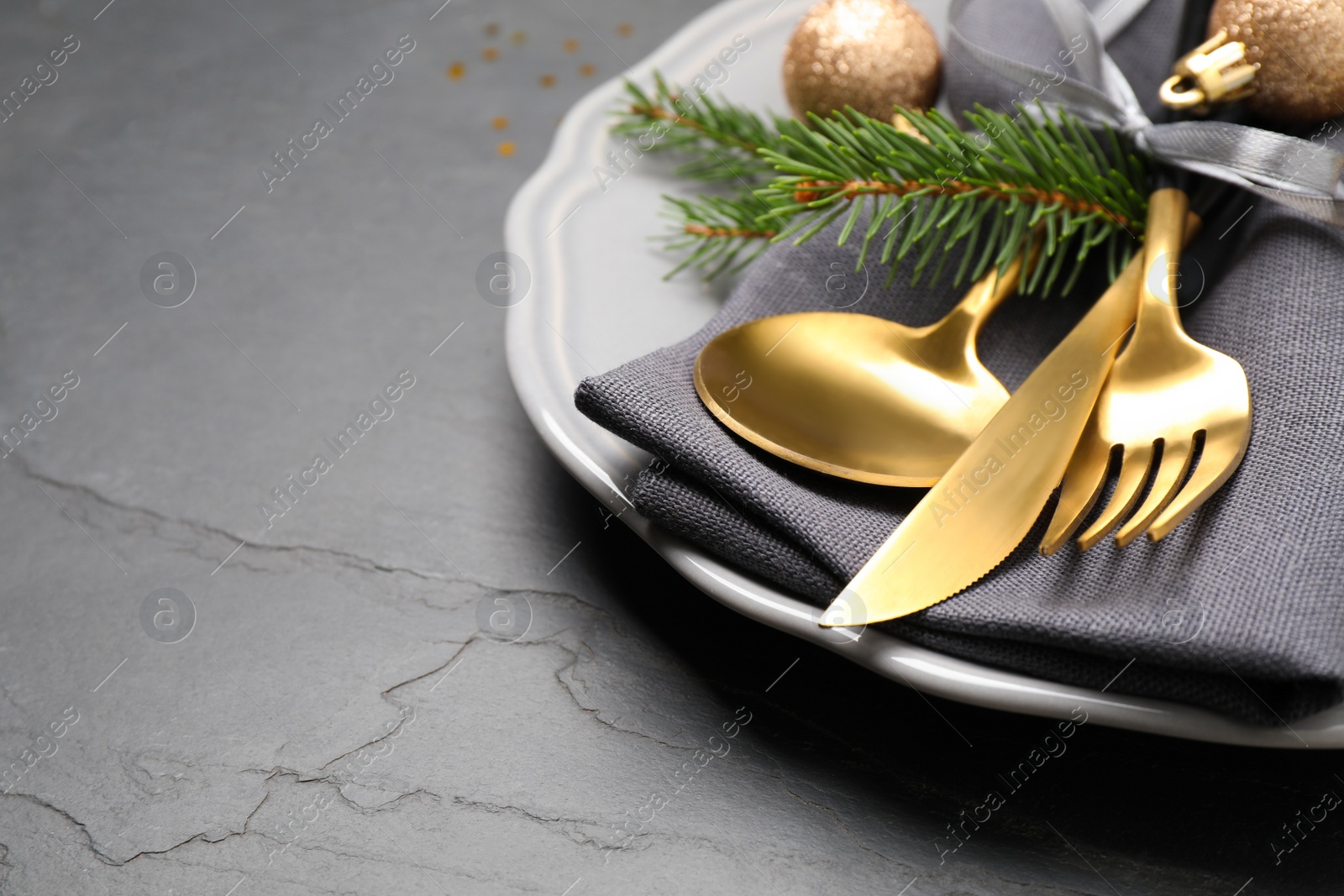 Photo of Festive table setting with beautiful dishware and Christmas decor on black background, closeup. Space for text