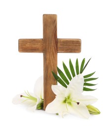 Photo of Wooden cross, lily flowers and palm leaf on white background. Easter attributes