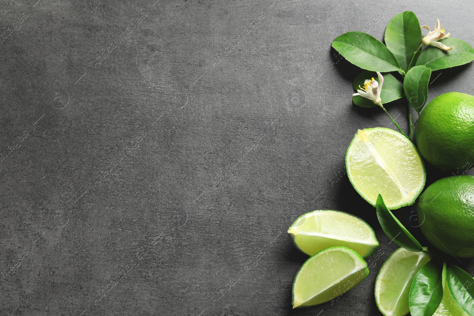 Photo of Composition with fresh ripe limes on gray background, top view