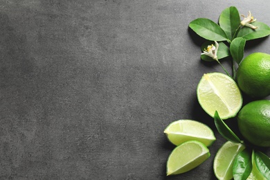 Composition with fresh ripe limes on gray background, top view