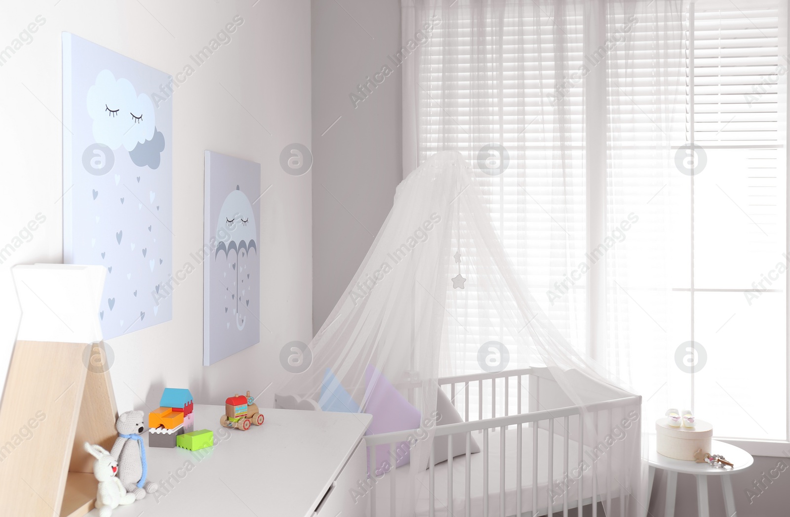 Photo of Baby room interior with cute posters and comfortable crib