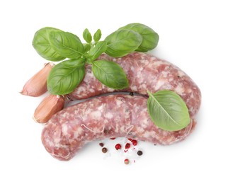 Photo of Raw homemade sausages and different spices isolated on white, top view