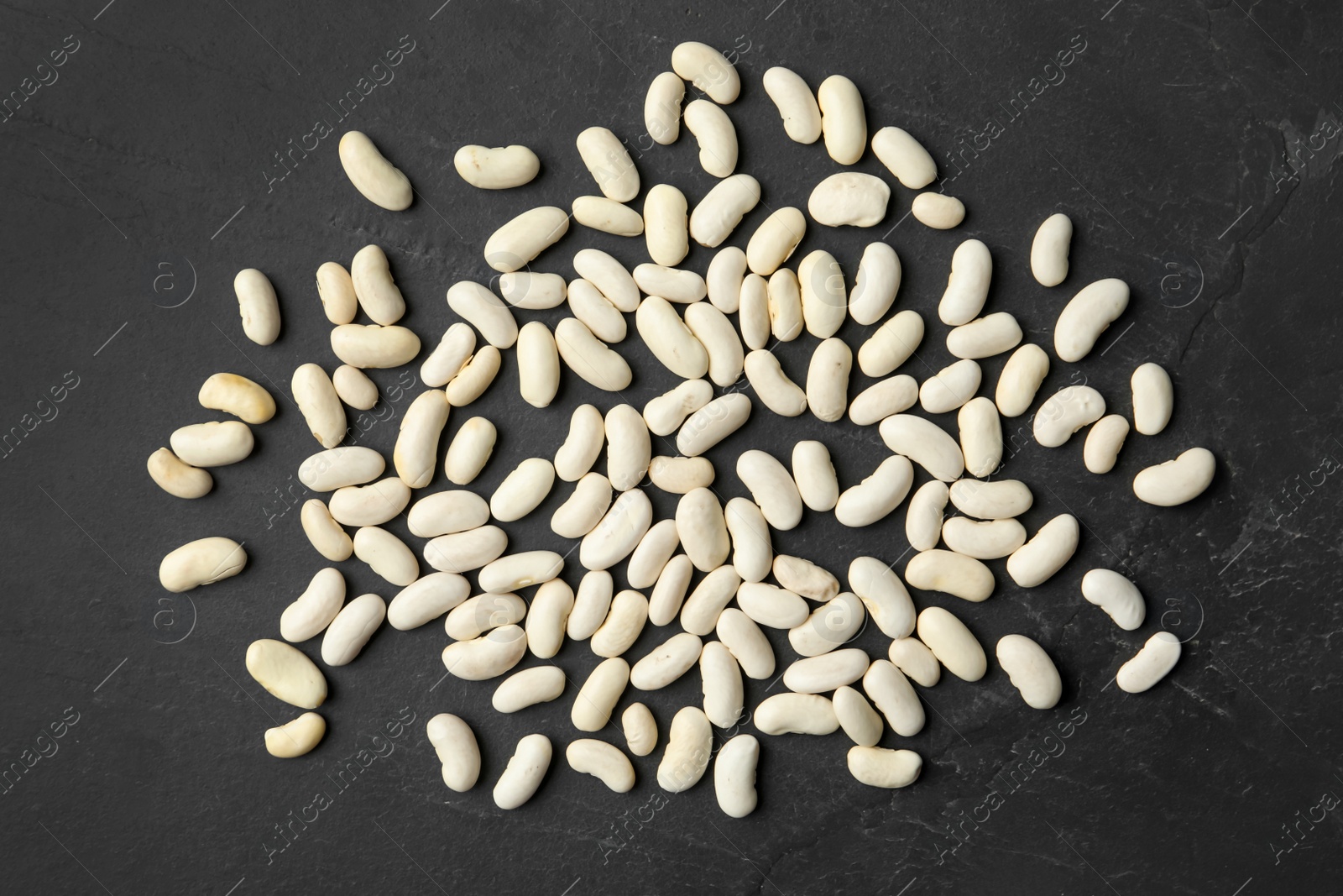 Photo of Raw beans on black background, flat lay. Vegetable seeds