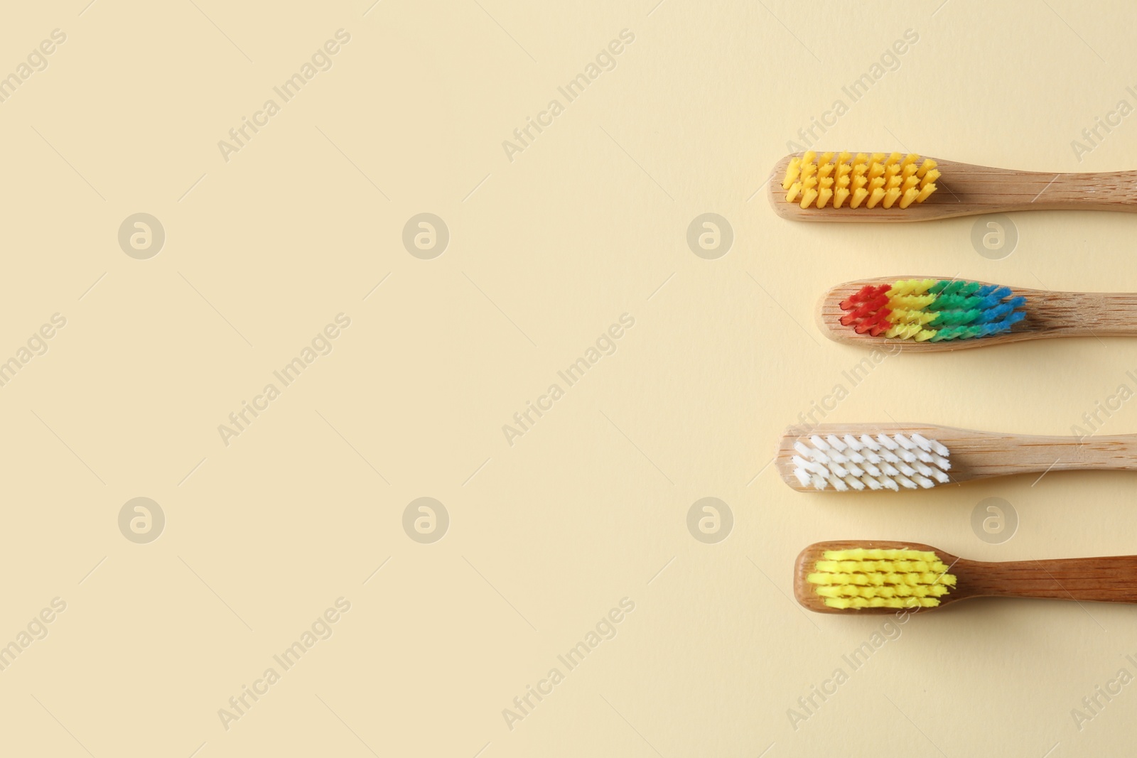 Photo of Different toothbrushes and space for text on color background, top view