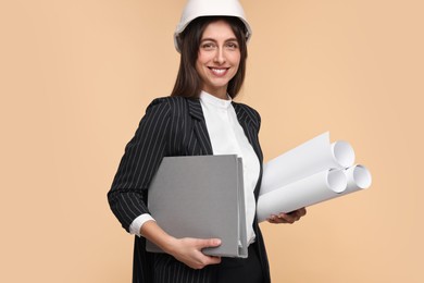 Photo of Architect in hard hat with drafts and folder on beige background