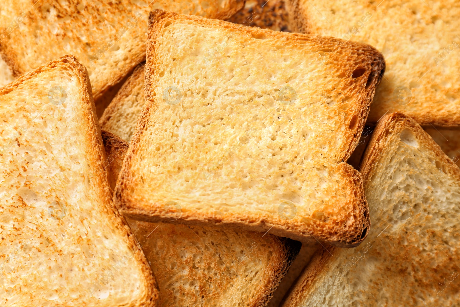 Photo of Toasted slices of bread as background, closeup