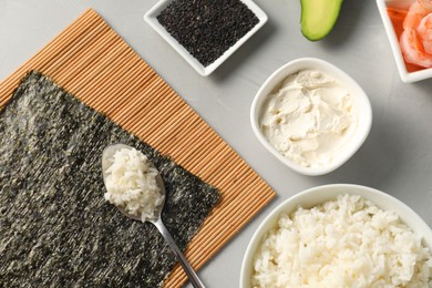 Photo of Flat lay composition with ingredients for sushi on grey table