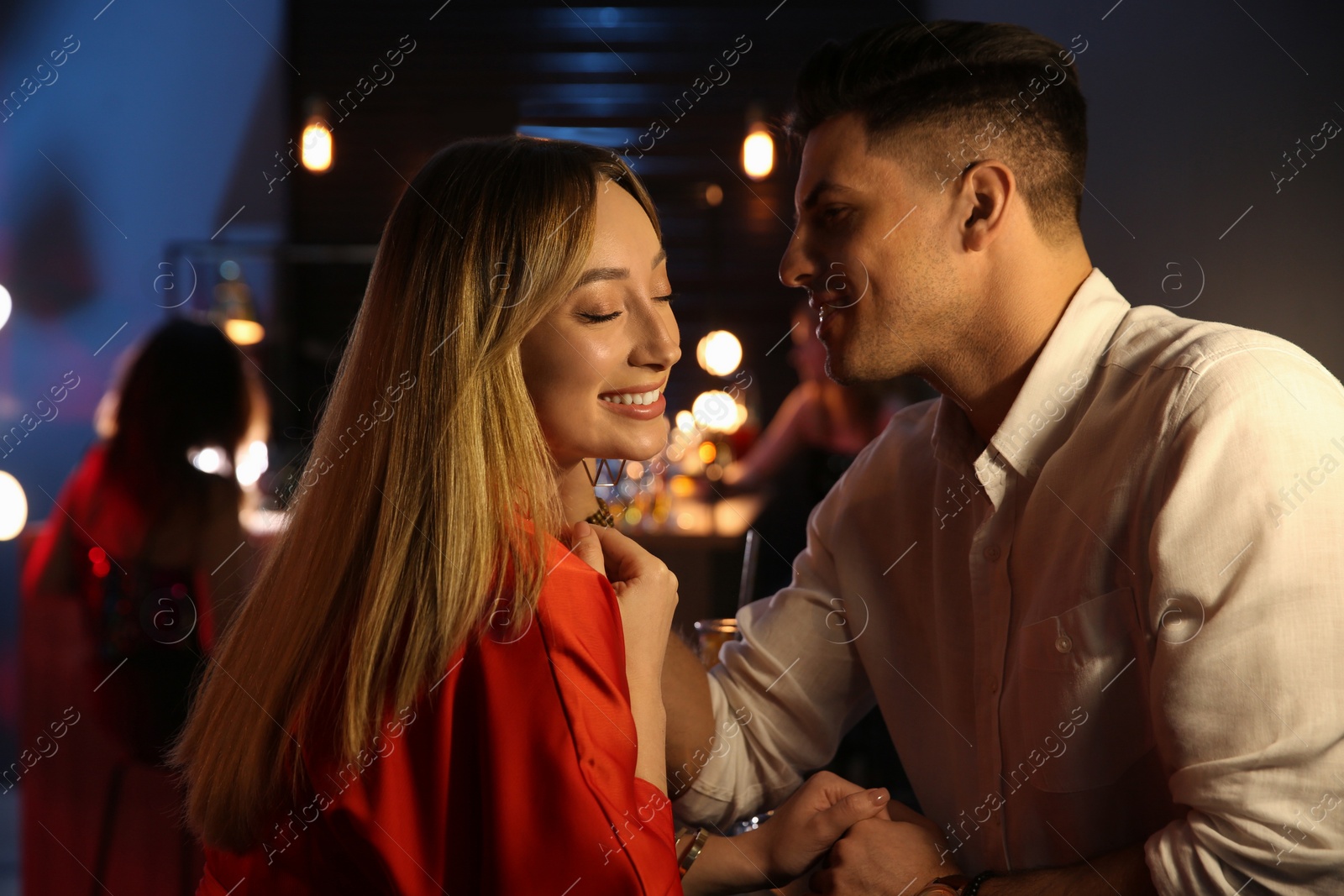 Photo of Man and woman flirting with each other in bar