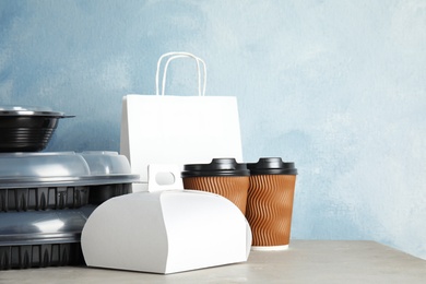 Photo of Various takeout containers on table, space for text. Food delivery service