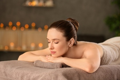 Beautiful young woman relaxing in spa salon