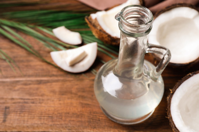 Photo of Coconut oil on wooden table. Space for text