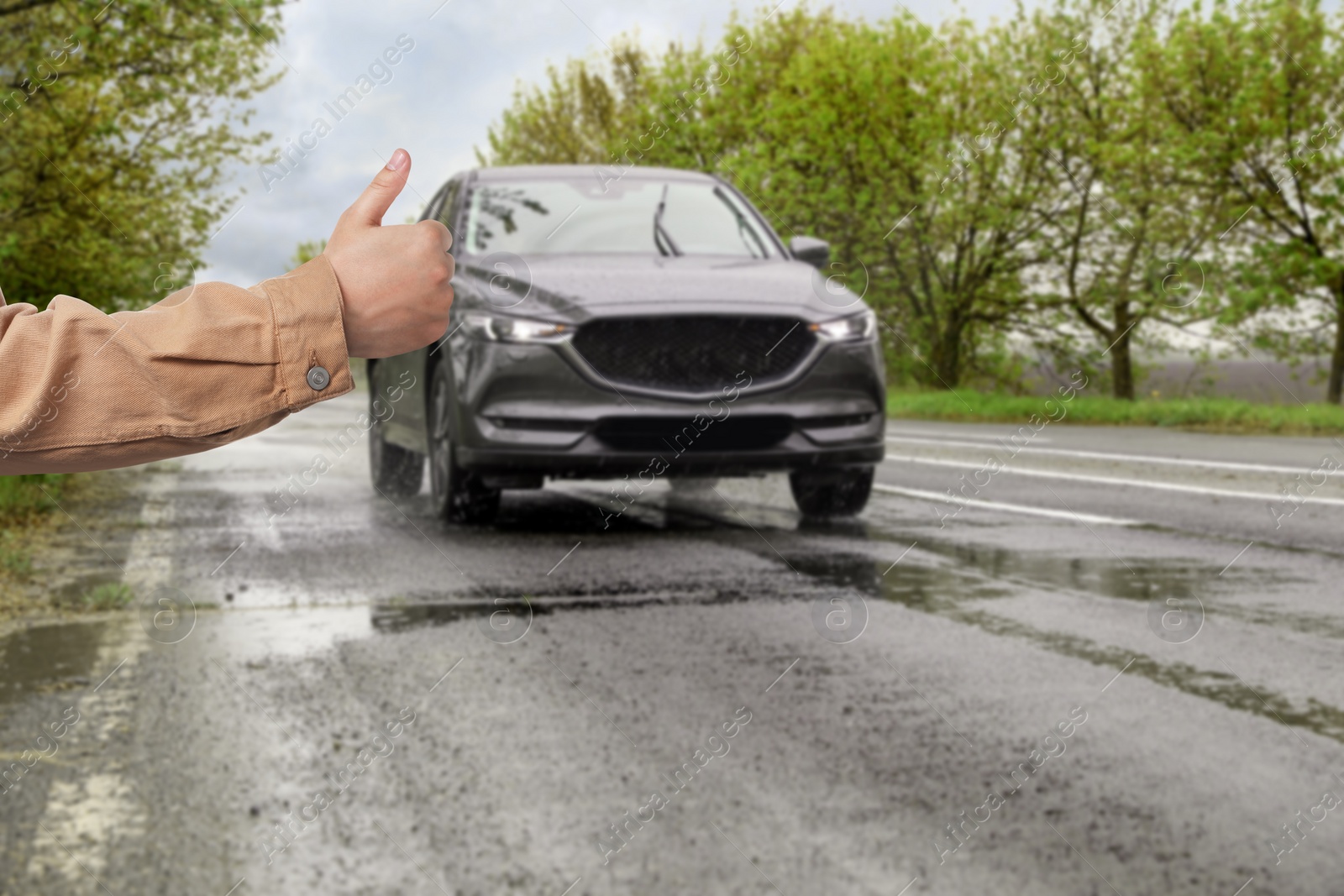 Image of Man catching car on road, closeup. Hitchhiking trip