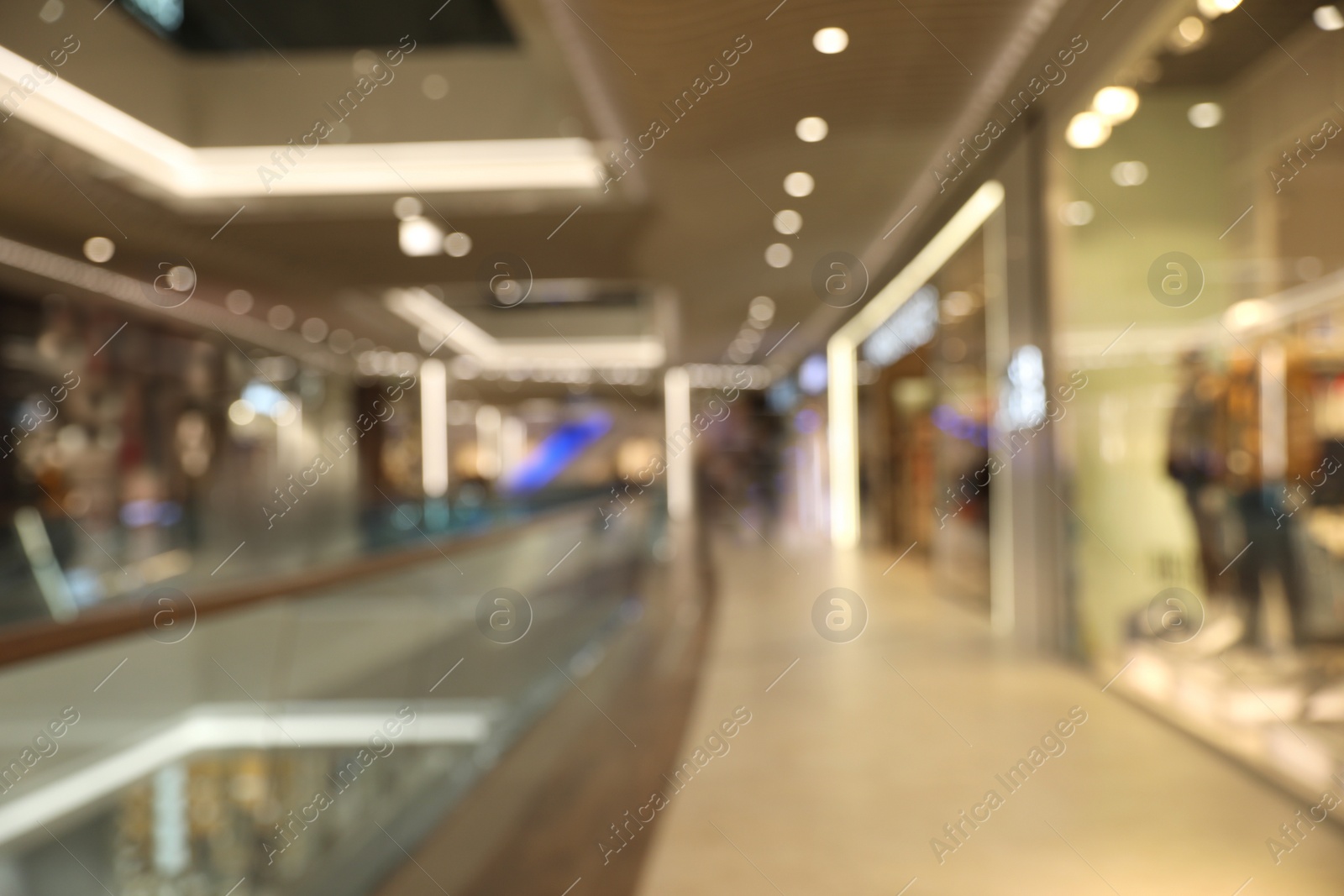 Photo of Blurred view of modern shopping mall interior. Bokeh effect