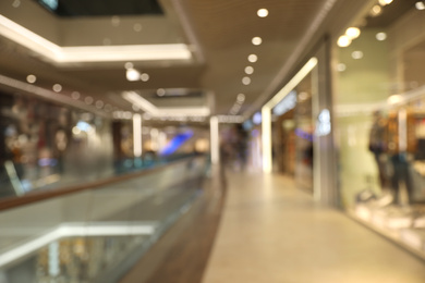 Photo of Blurred view of modern shopping mall interior. Bokeh effect